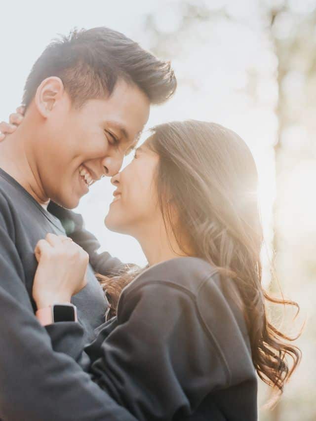 a couple in grey shirts hugging and smiling