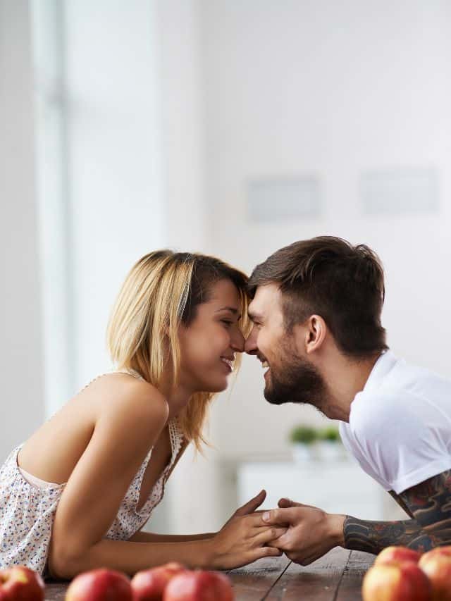 couple holding hands on a table