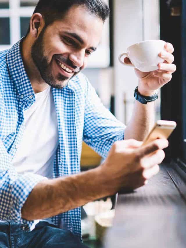 man sitting in cafe texting