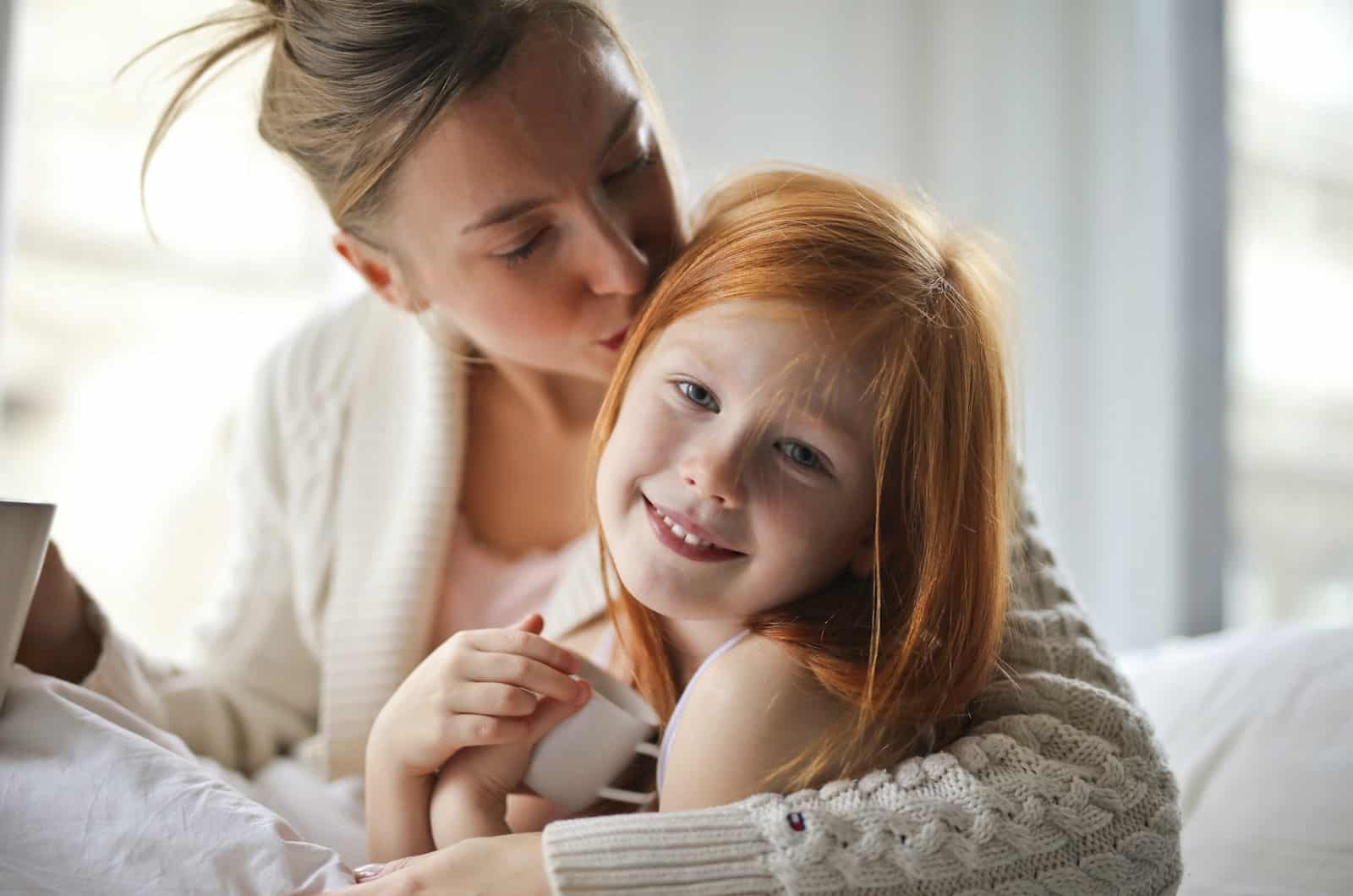 woman kissing her child