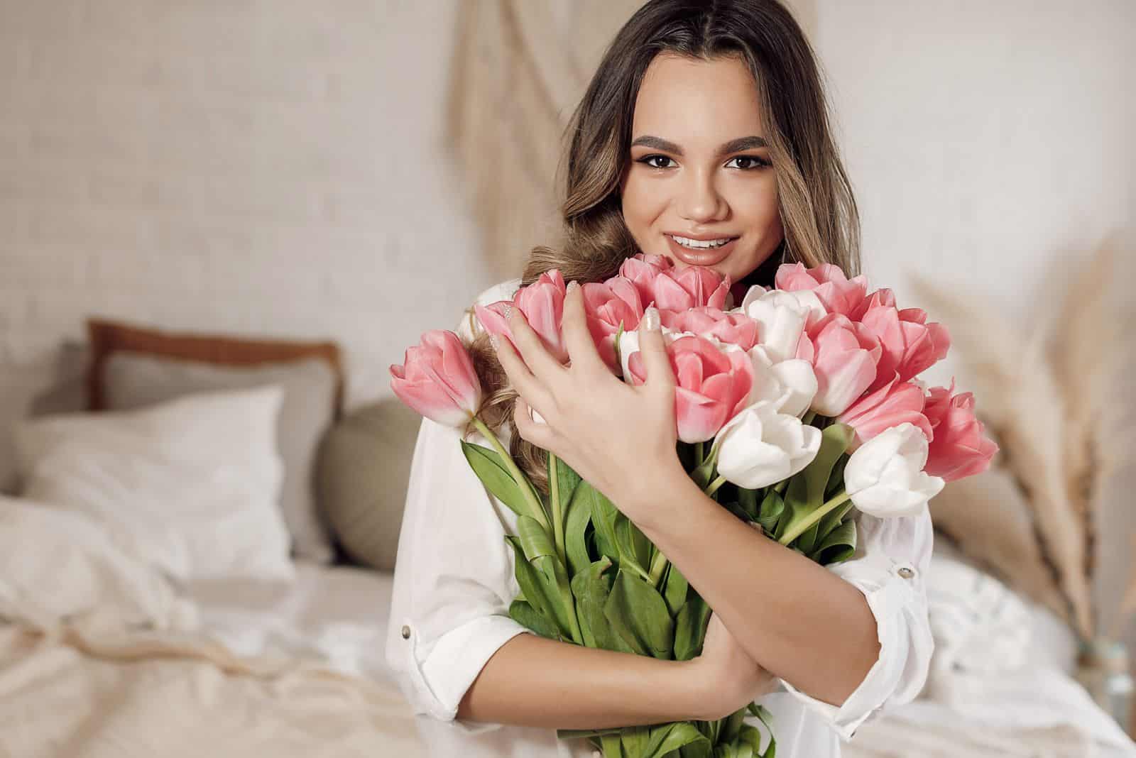 smiling woman with a beautiful bouquet of tulips