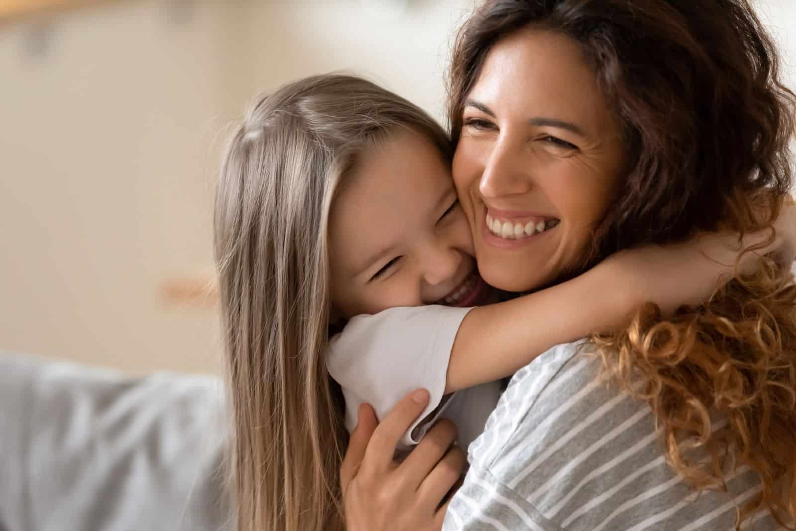smiling woman in an embrace with a child