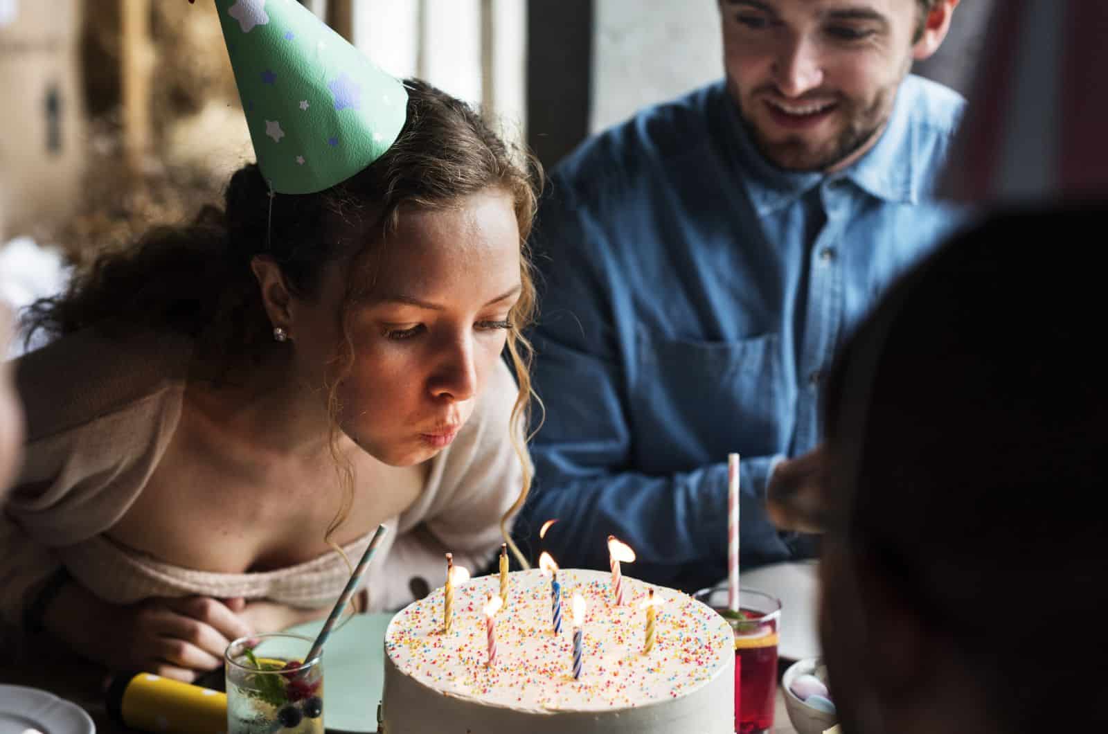 woman blowing out her birthday candles