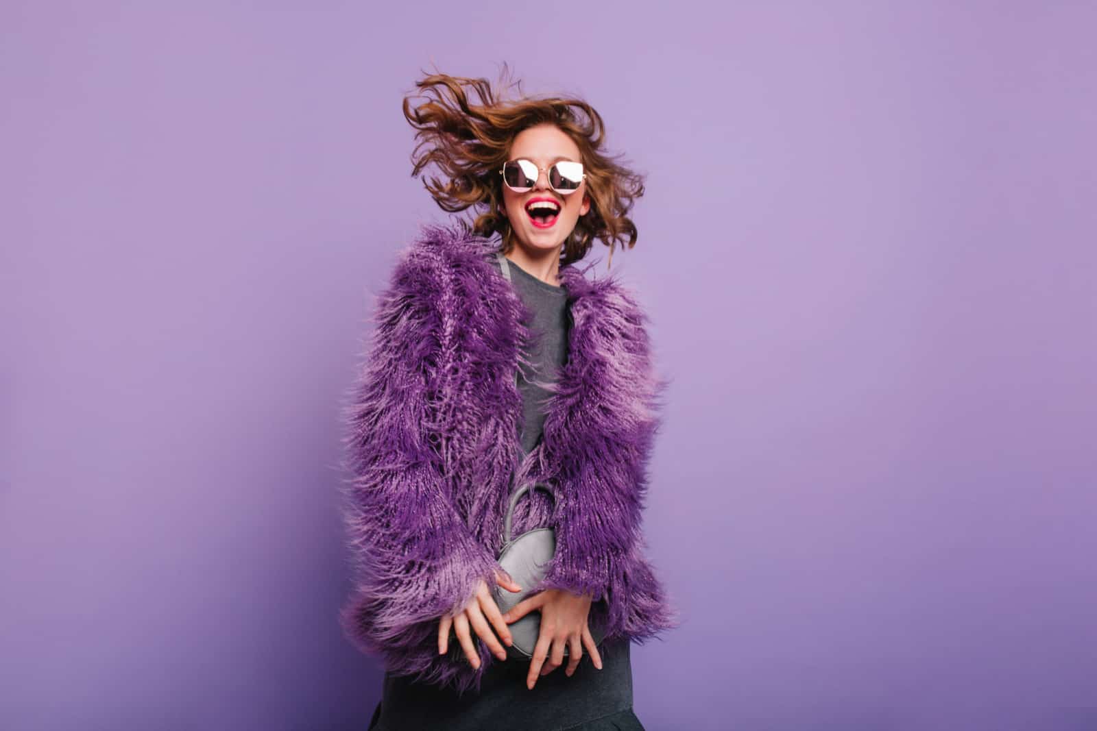 confident girl in purple coat posing