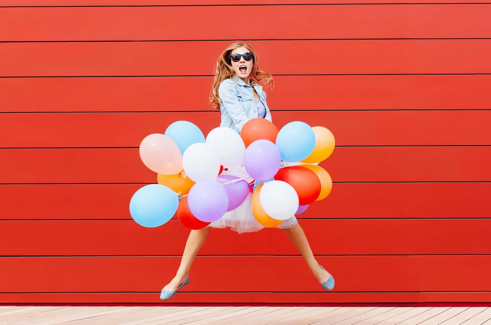 happy woman jumping with baloons