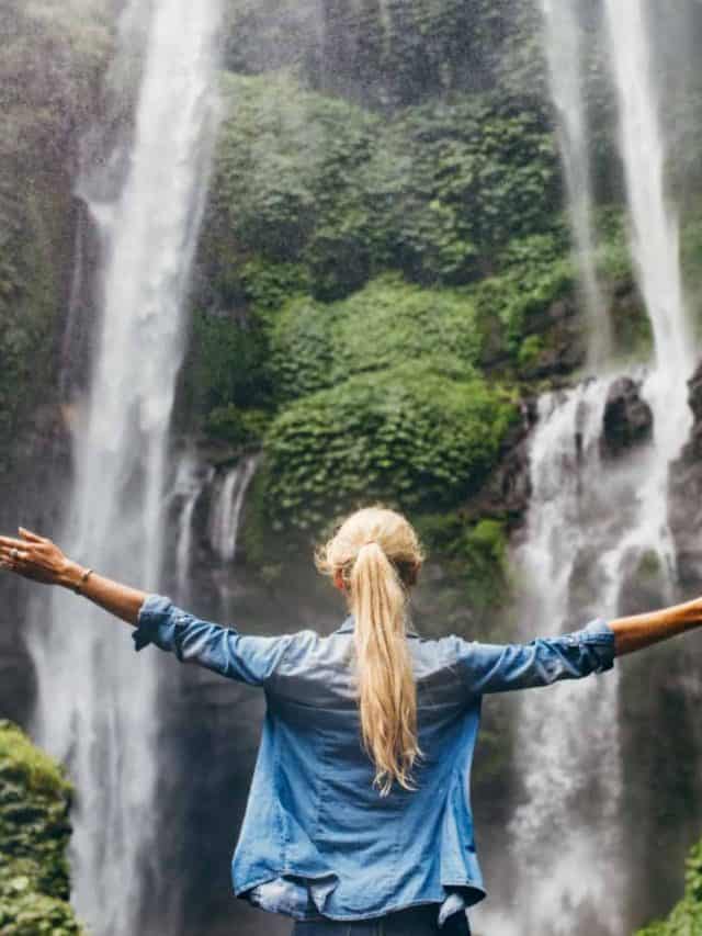 woman in front of a waterfall