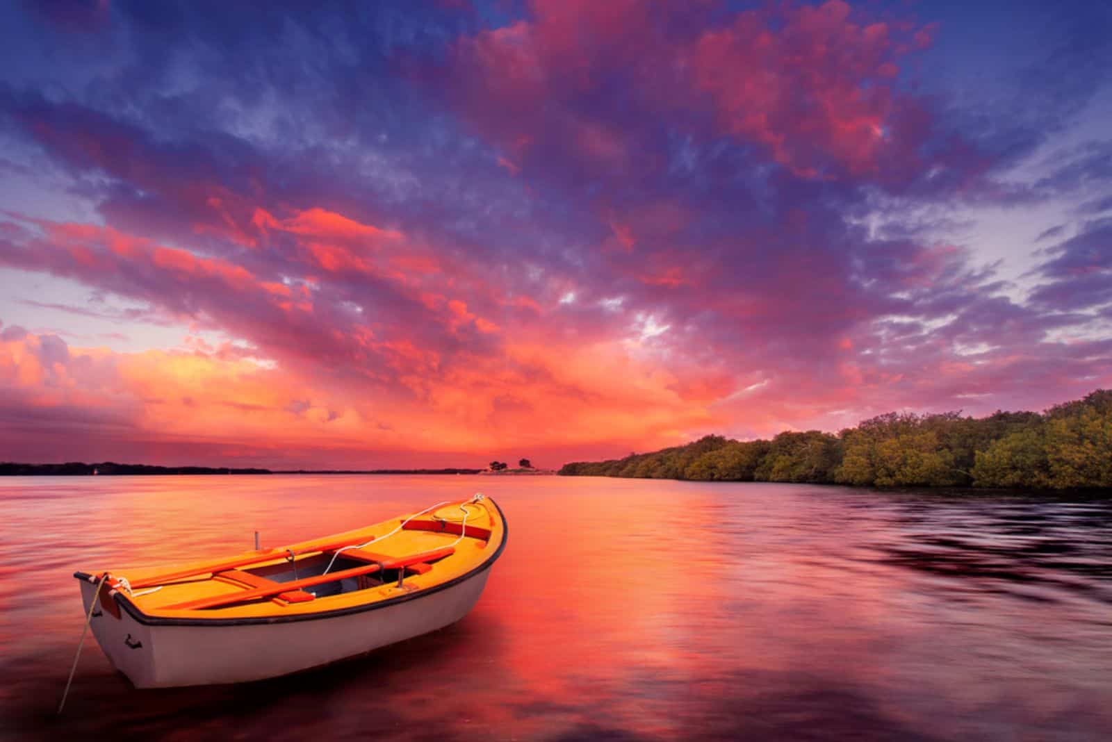 A rowboat watches an amazing sunset