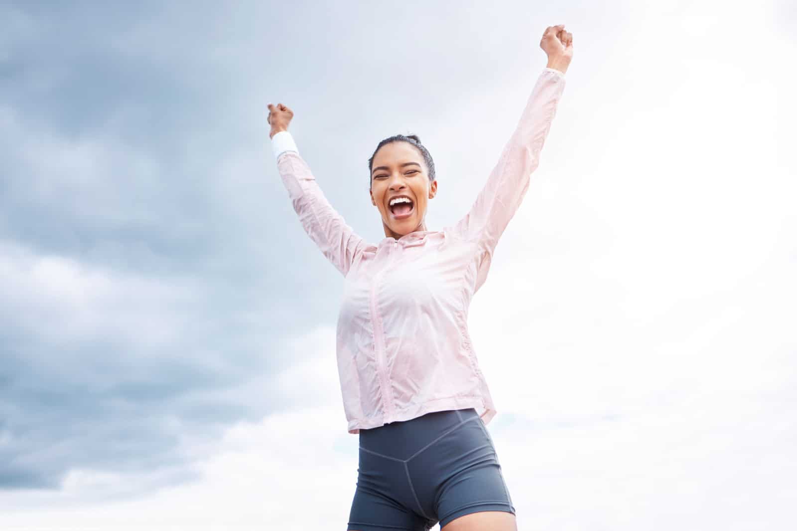 fit woman celebrating victory and goal achievement
