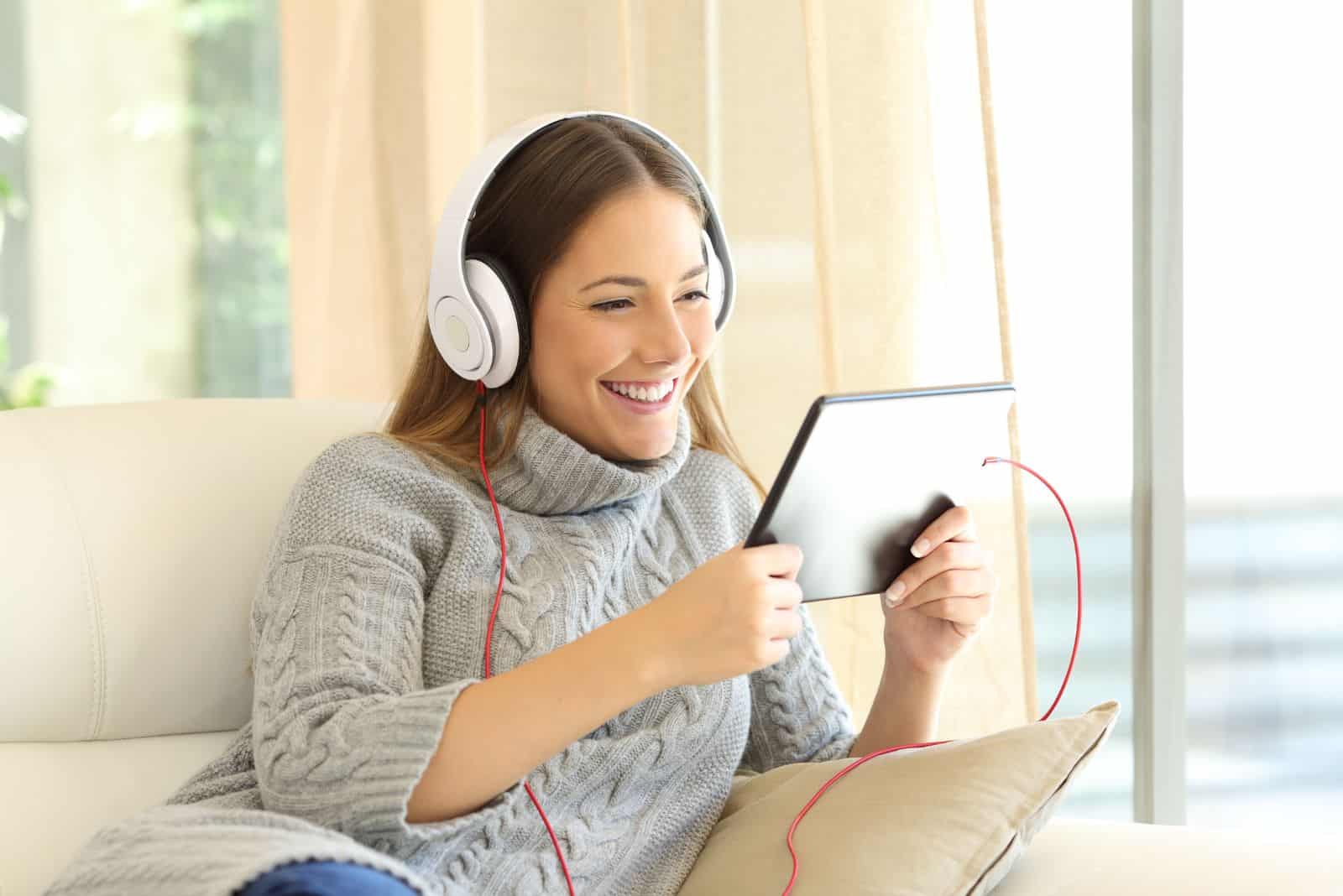 smiling girl listens to music