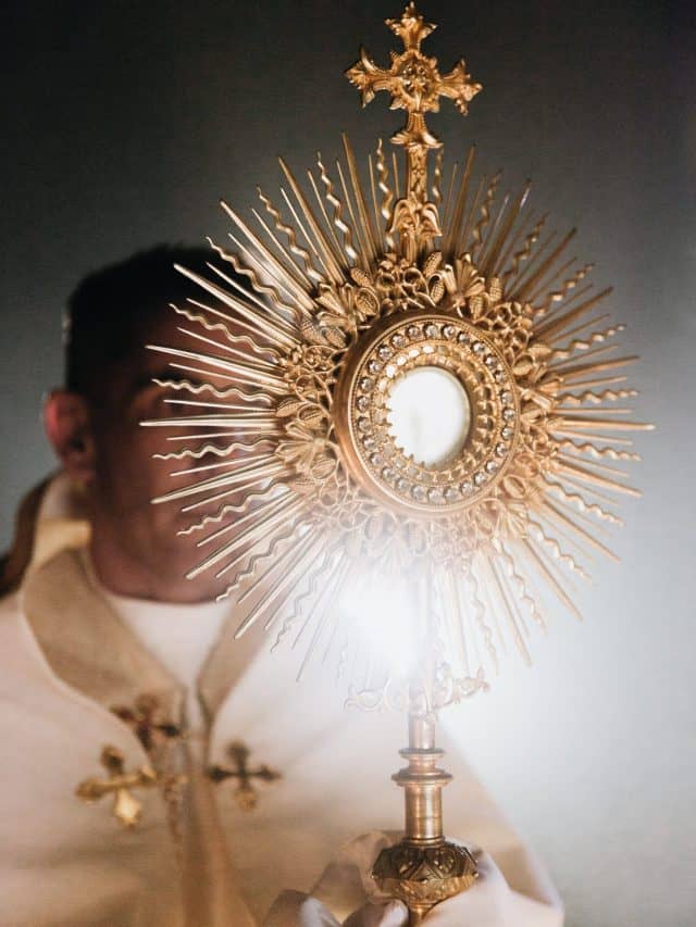 christian man looking and holding a cross