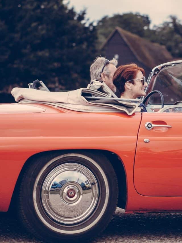 vintage couple driving in a old vintage car