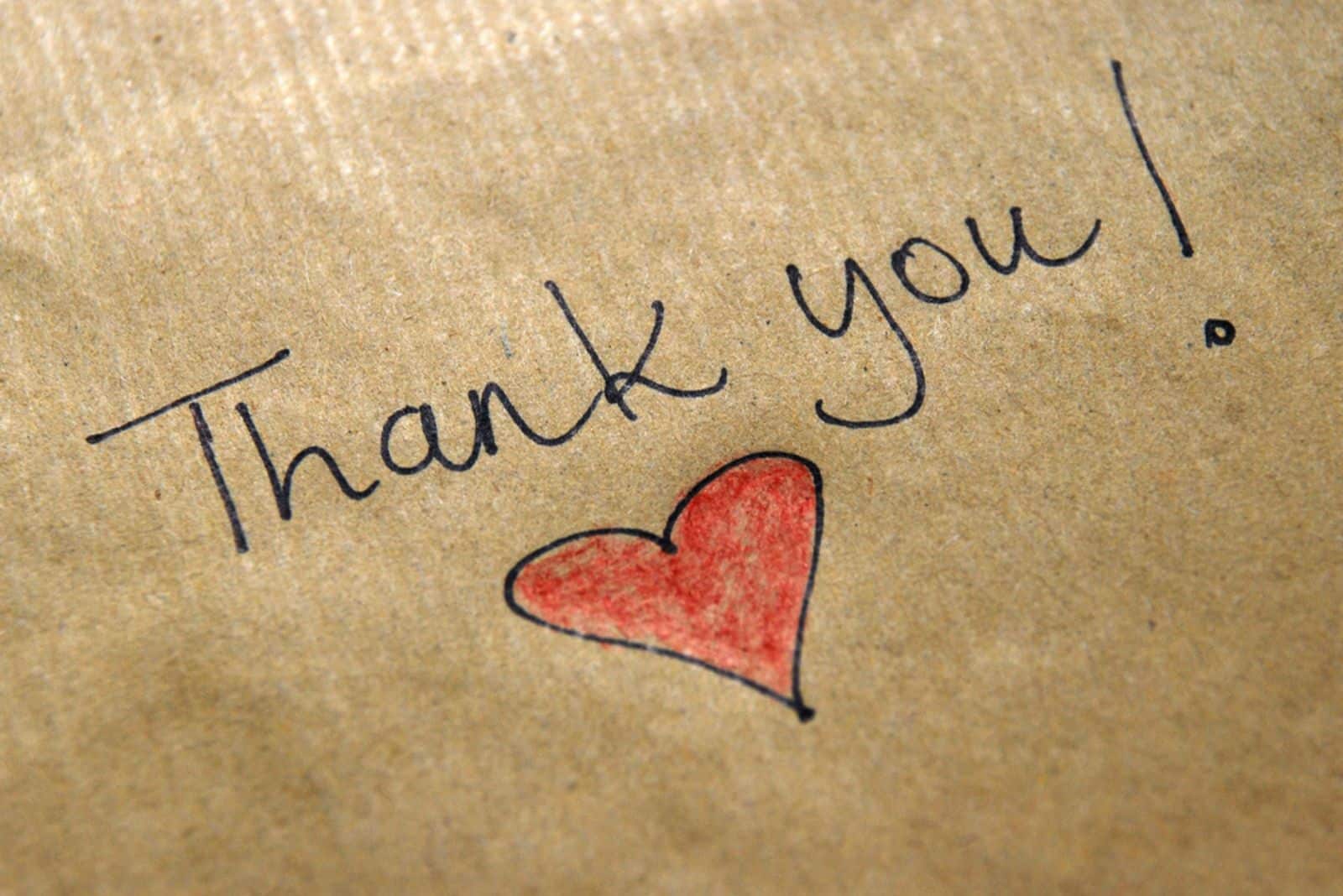 thank you written on the brown paper with red heart