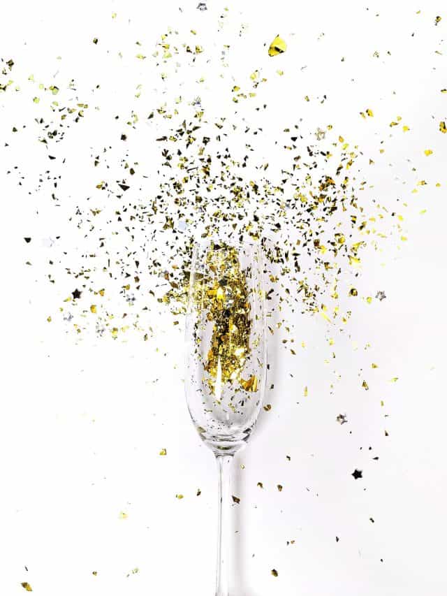 glass celebration for birthday with gold sparks