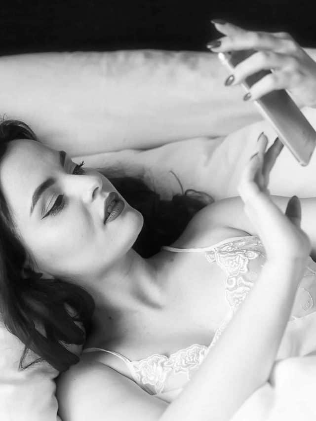 woman in morning holding a phone to text