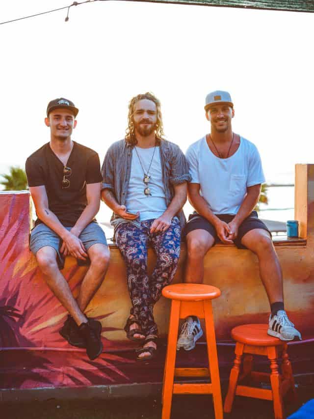 three male friends sitting and having fun
