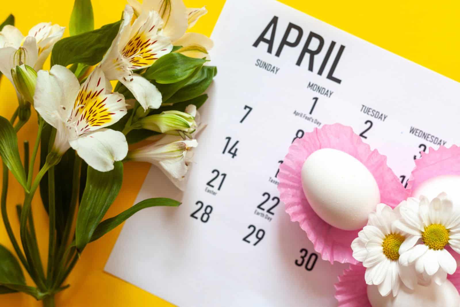 April 2020 calendar, cute pure white easter eggs and white flowers on yellow background
