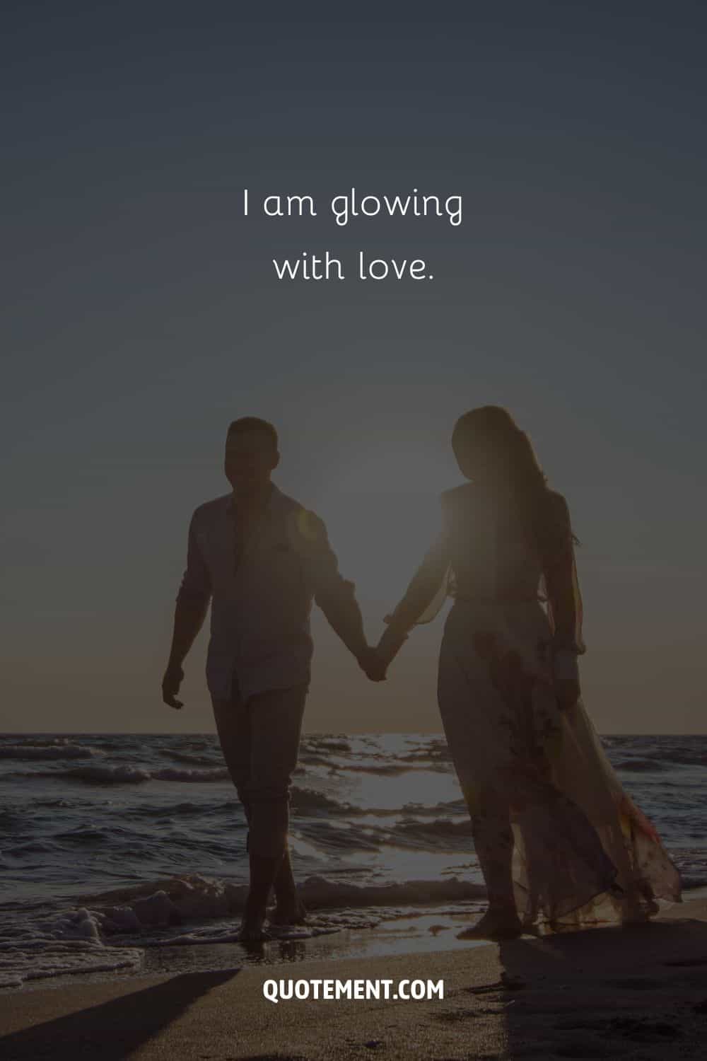 Image of a romantic beachwalk representing an affirmation for attracting love.
