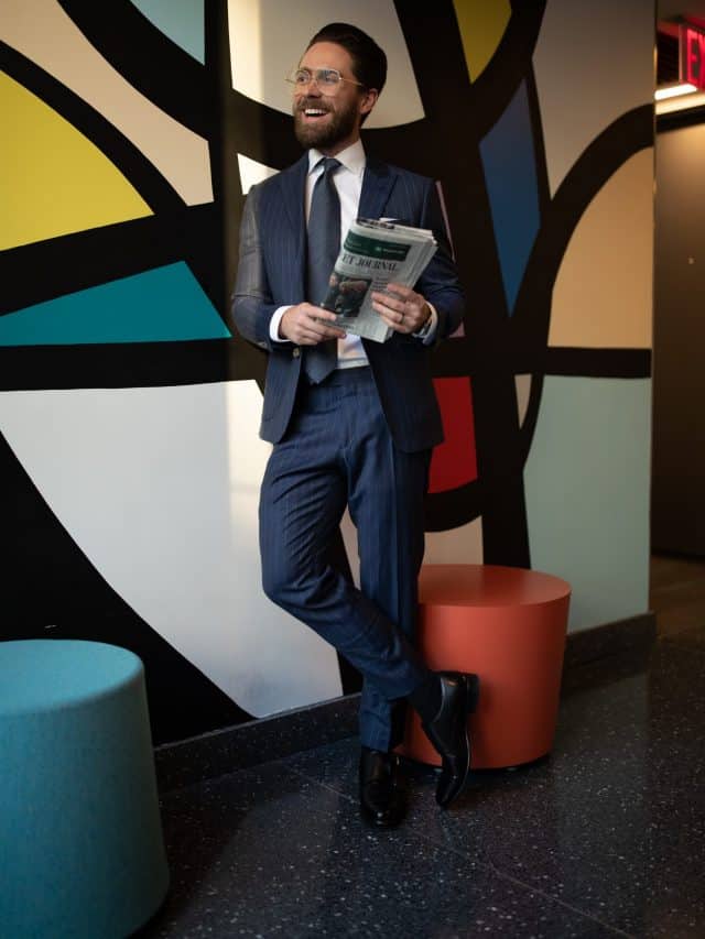 successful man in suit standing proud of his new business