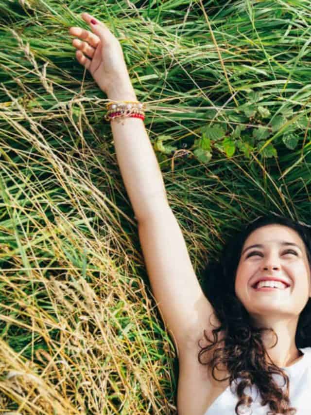 woman laughing in a bed of grass