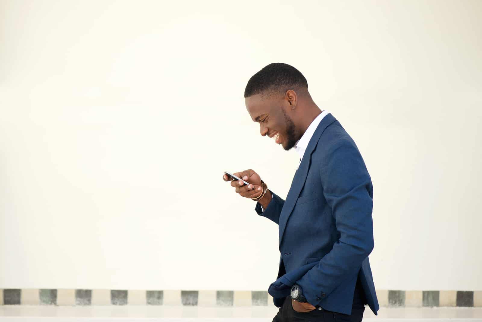 man in a suit looking at his phone