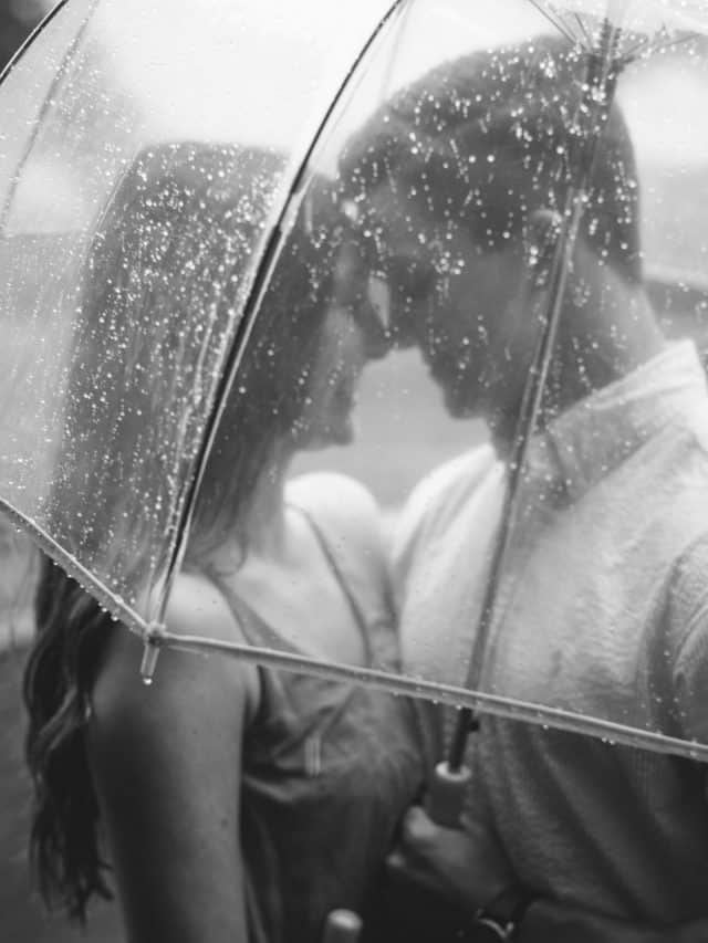 couple in the rain dancing under the umbrella