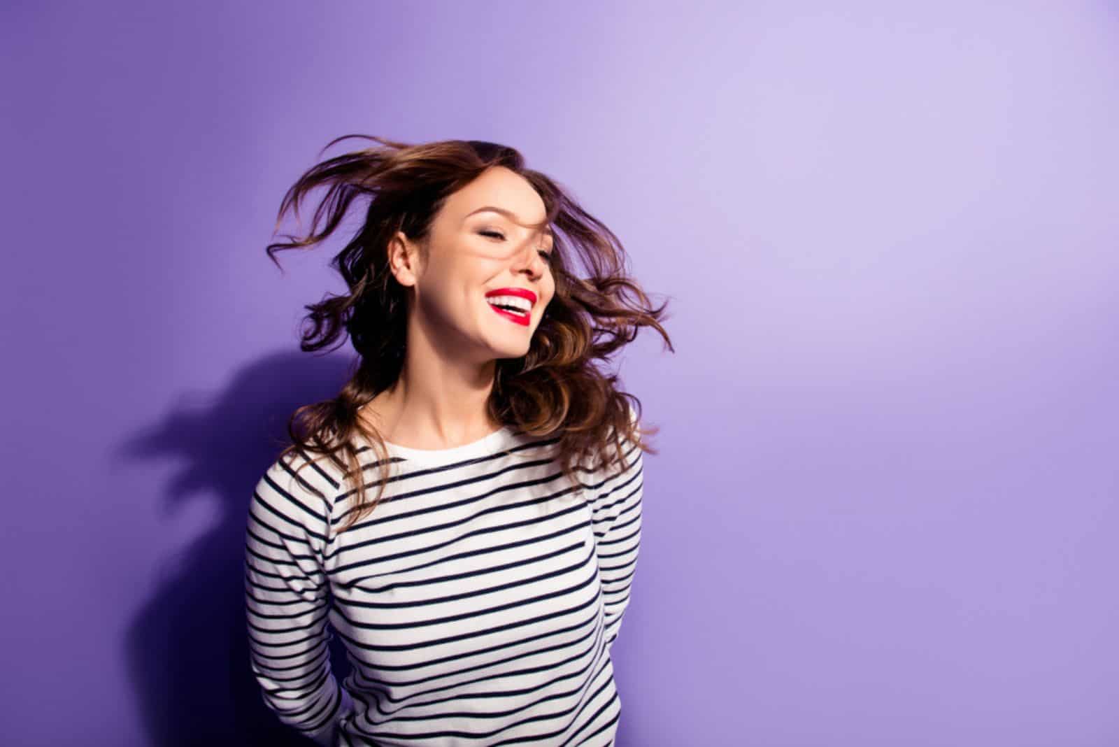 girl having flying hair isolated on violent background