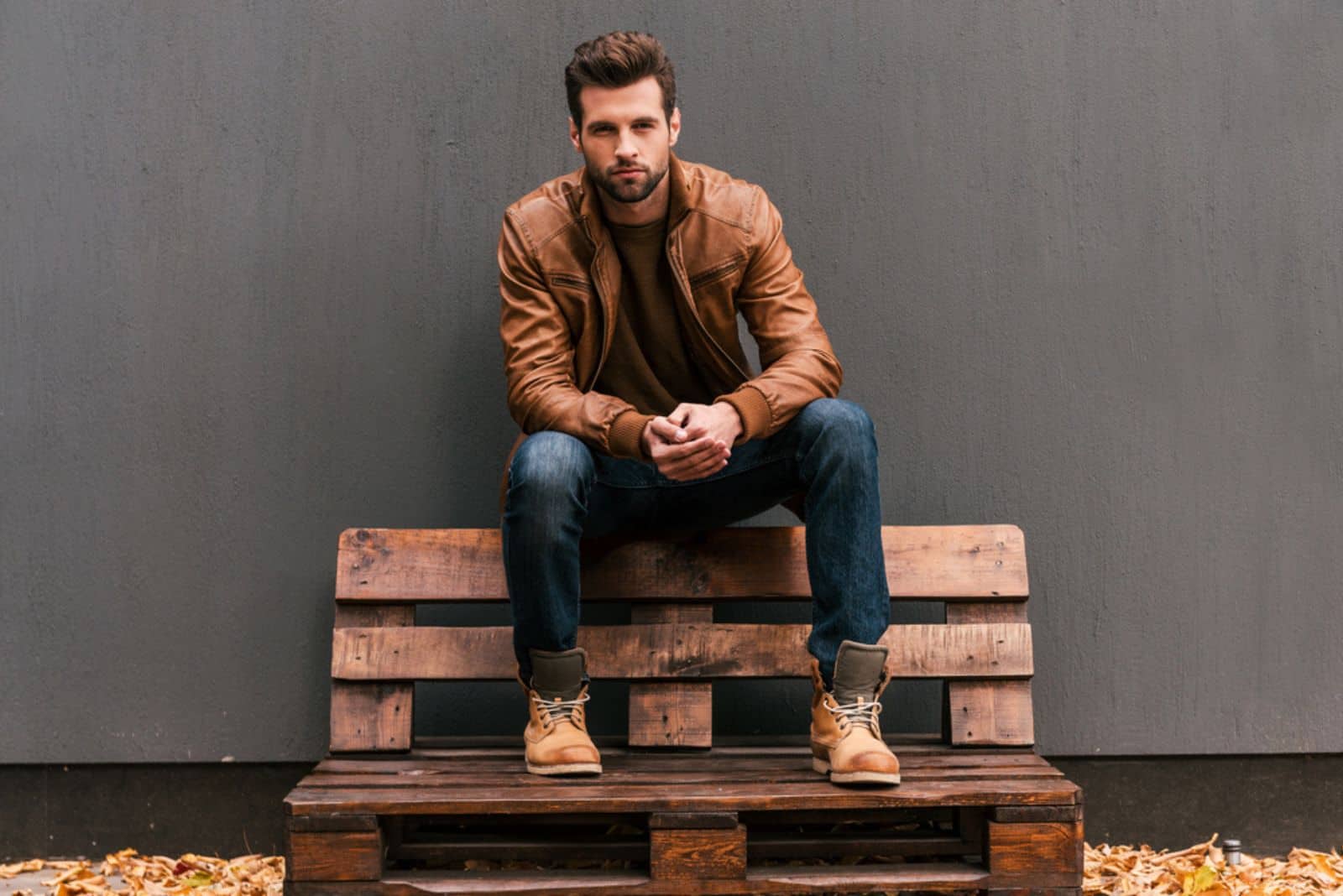 pensive man sitting on a wooden chair