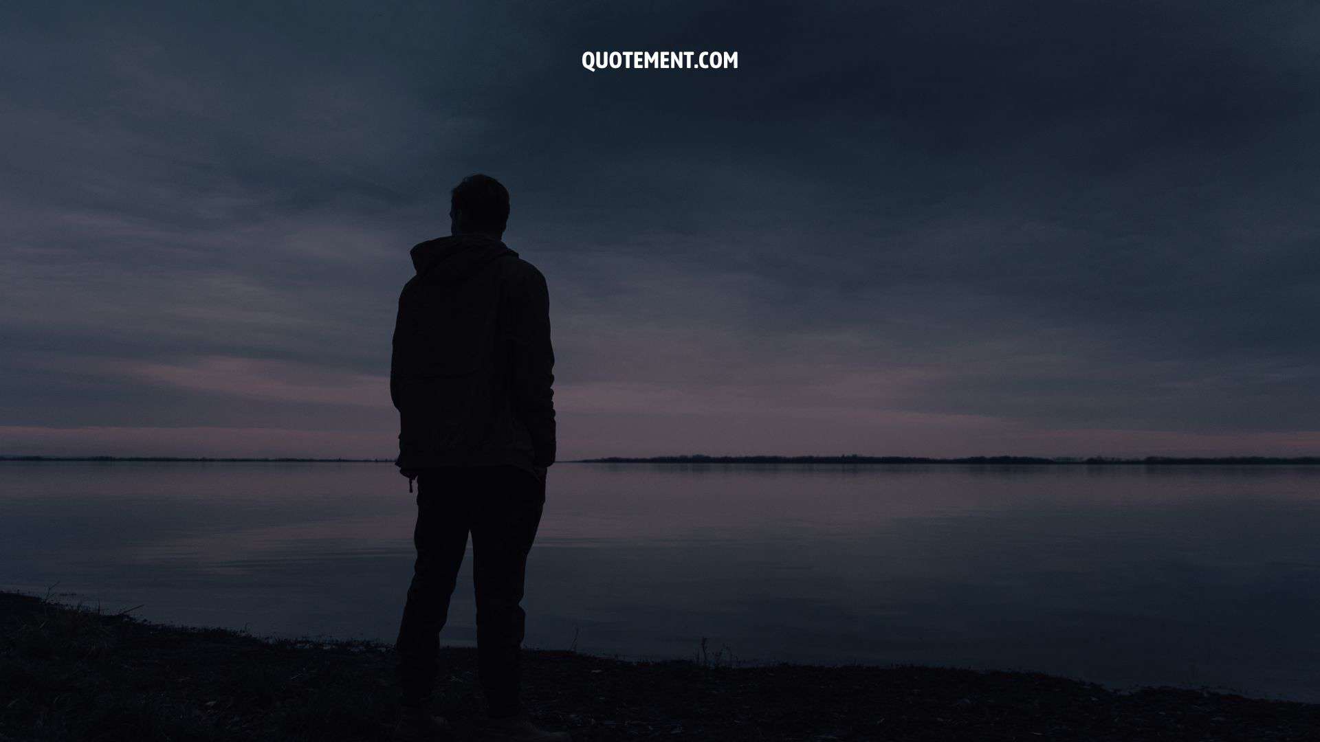 man standing alone in front of the ocean, concept of betrayal quotes