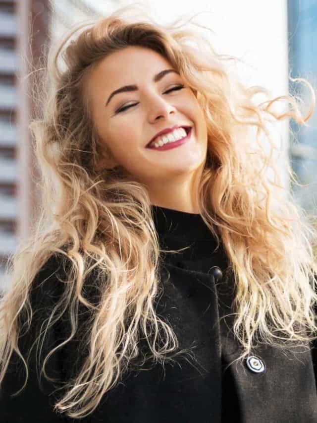 Outdoors lifestyle fashion portrait of happy stunning blonde girl