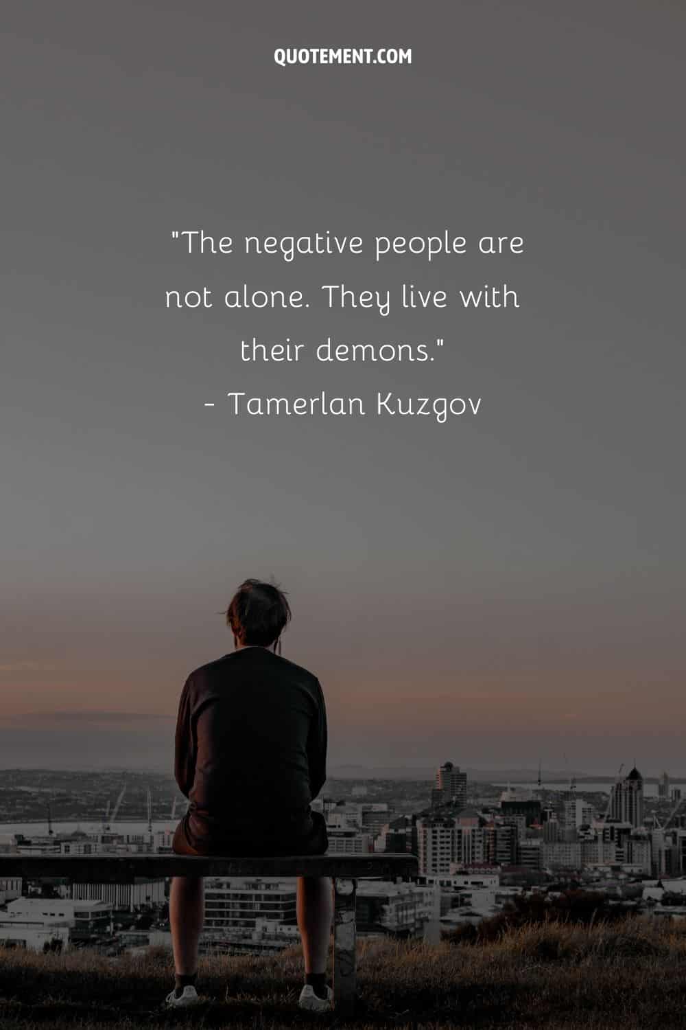 Top negative people quote and a man sitting on a bench looking down at the city