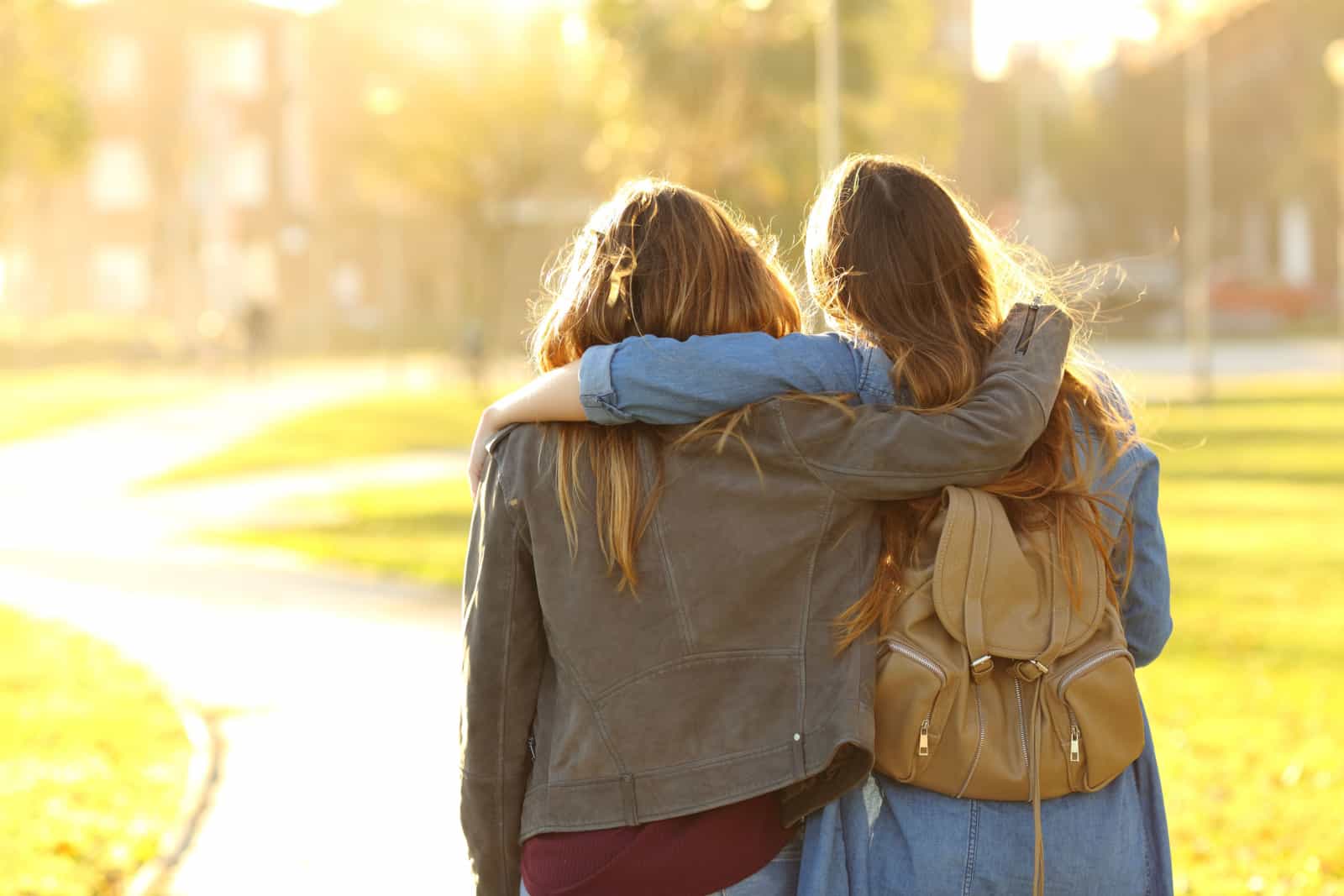 two friends hugging, one friend saying words of encouragement for her friend