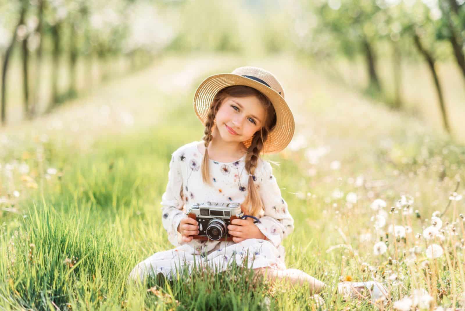 A child with a camera in nature