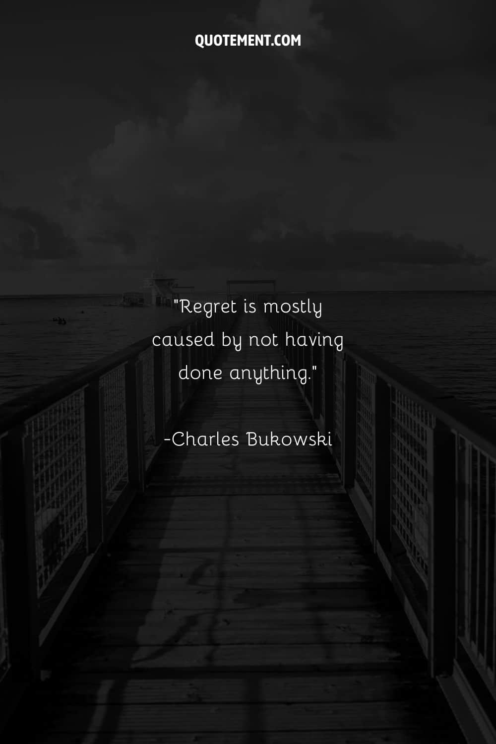A grayscale view of a bridge extending over the sea representing quote on regret