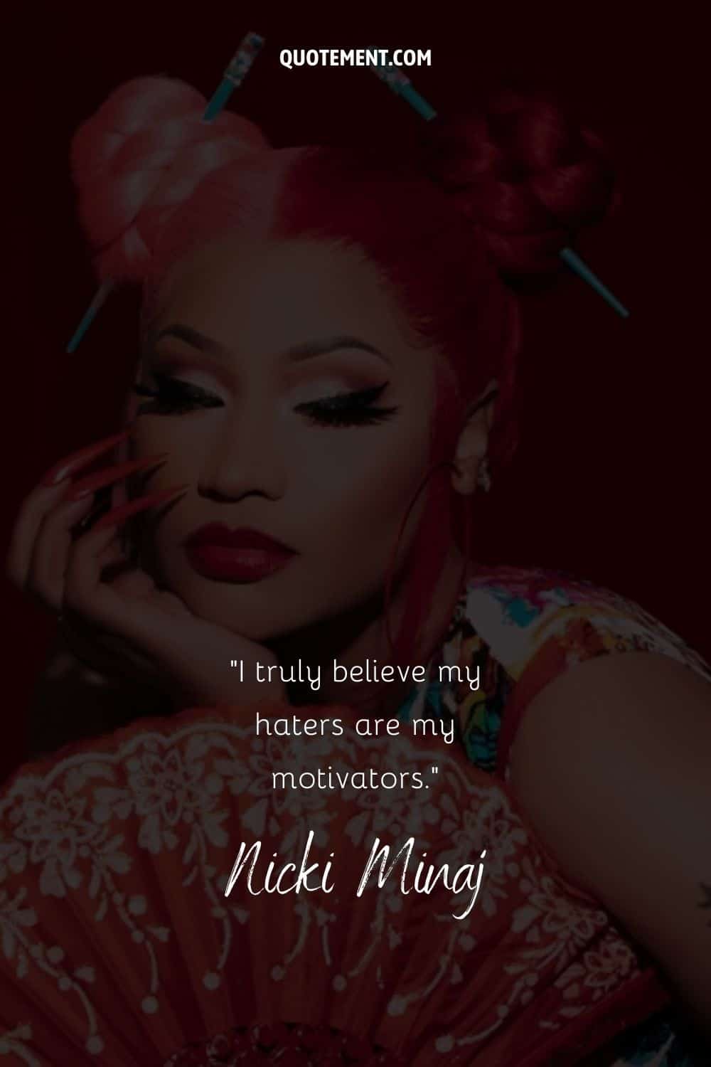 Motivational quote on haters by Nicki Minaj, and her photo in the background