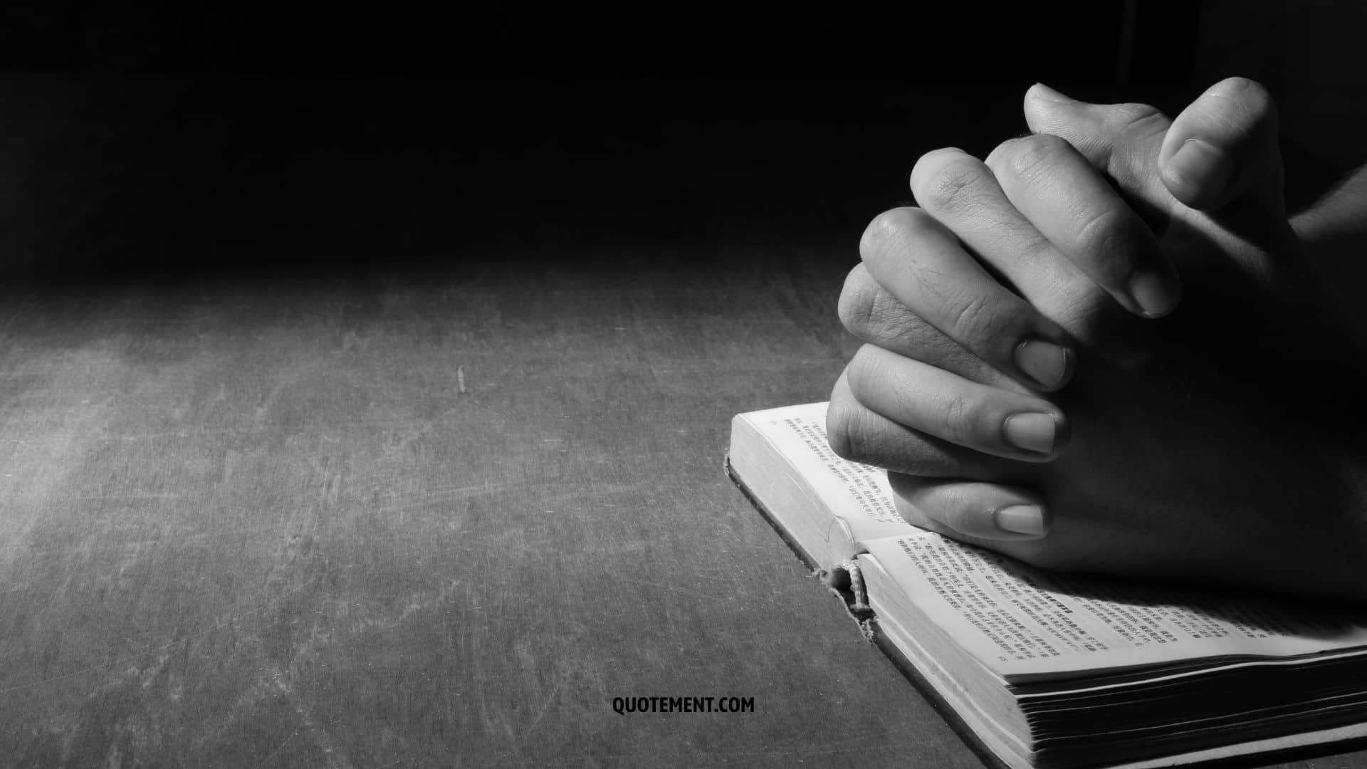 praying hands with book