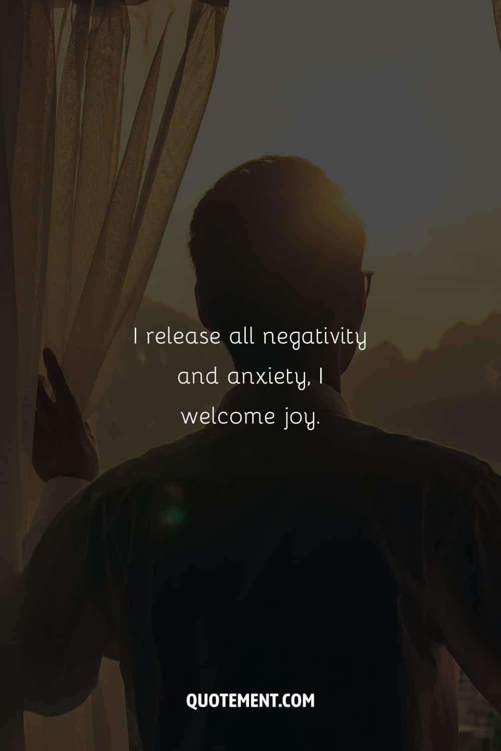 A man gazing through curtains representing an affirmation for anxiety.
