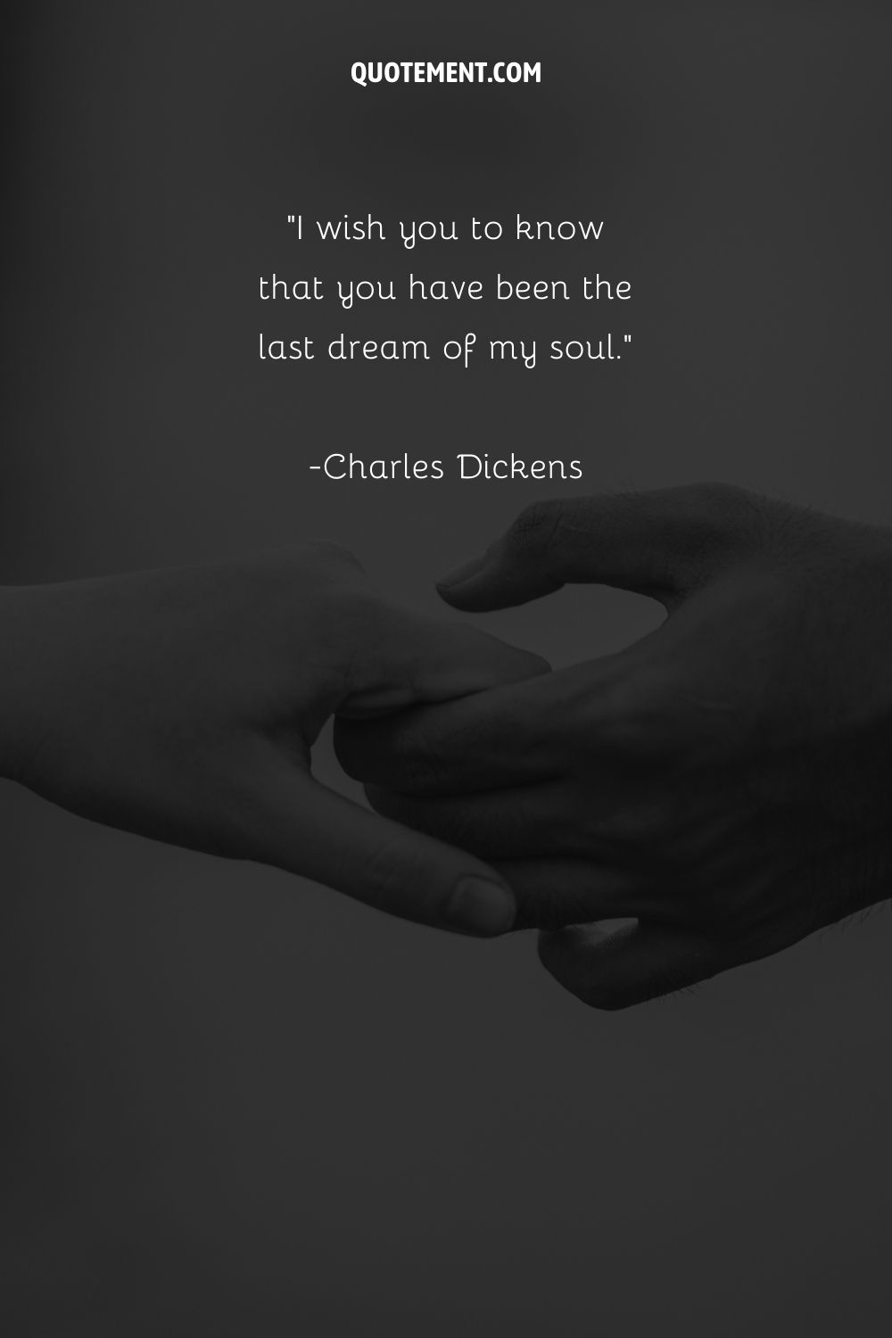 Monochrome hands interlocked representing Charles Dickens quote
