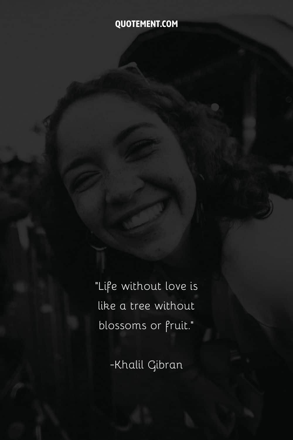 Monochrome image of a girl's laughter representing a quote on love
