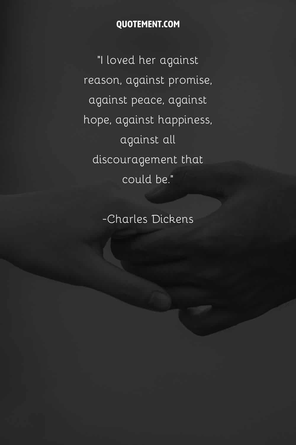 Monochrome image of interlocked hands representing a love quote by Charles Dickens
