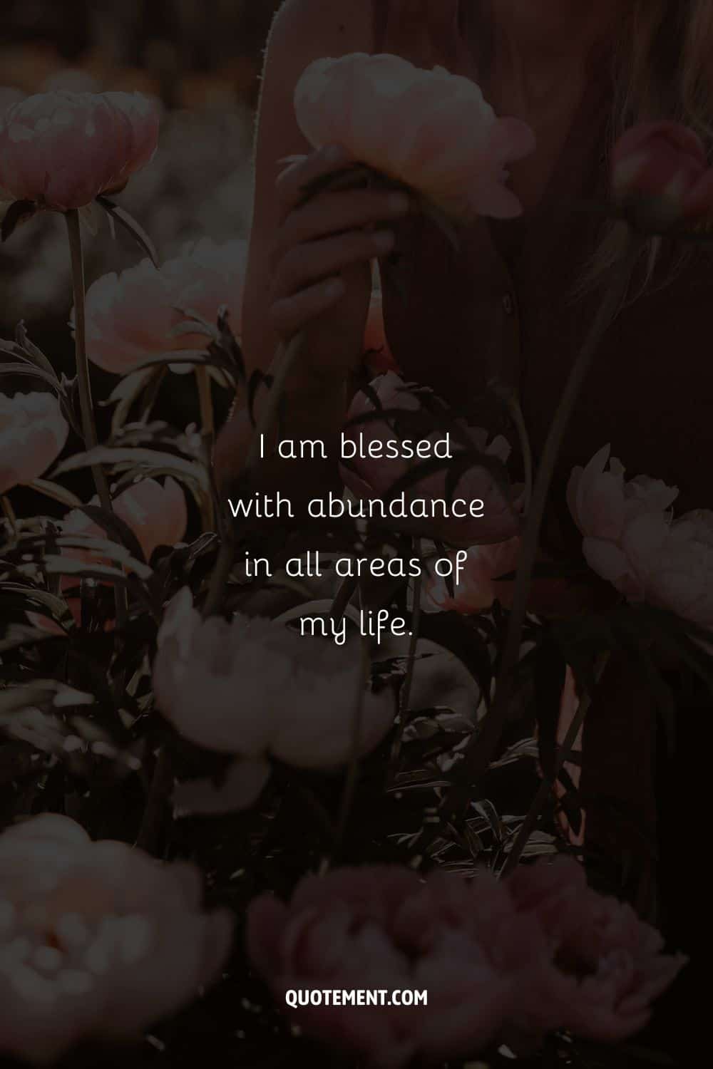 Young woman touching flowers image representing an abundance affirmation