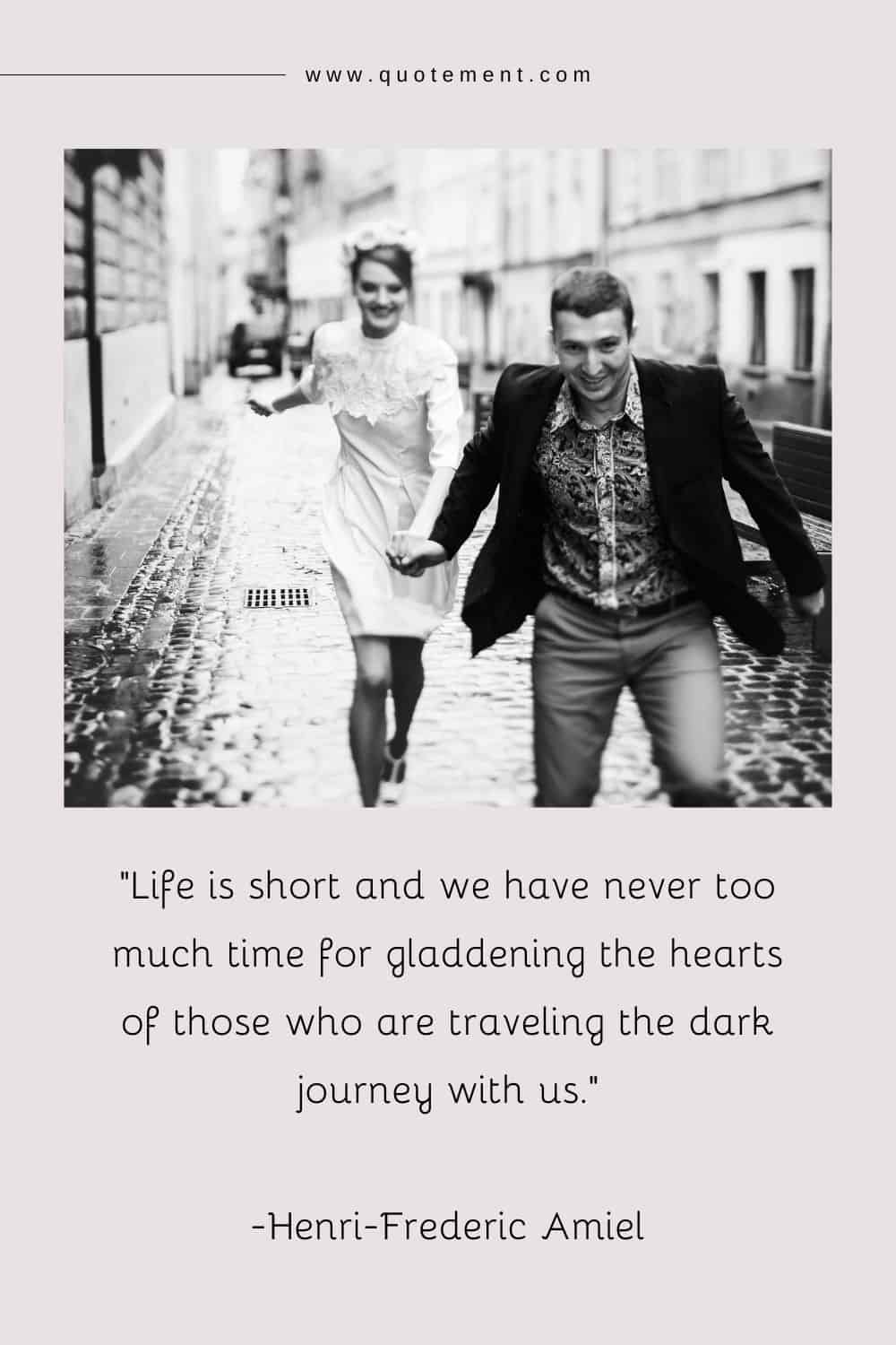 a smiling young couple on a rain-soaked street representing life is very short quote