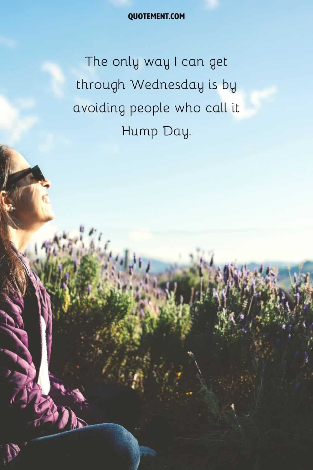 girl sitting and smiling amidst a lavender field representing a funny happy hump day quote