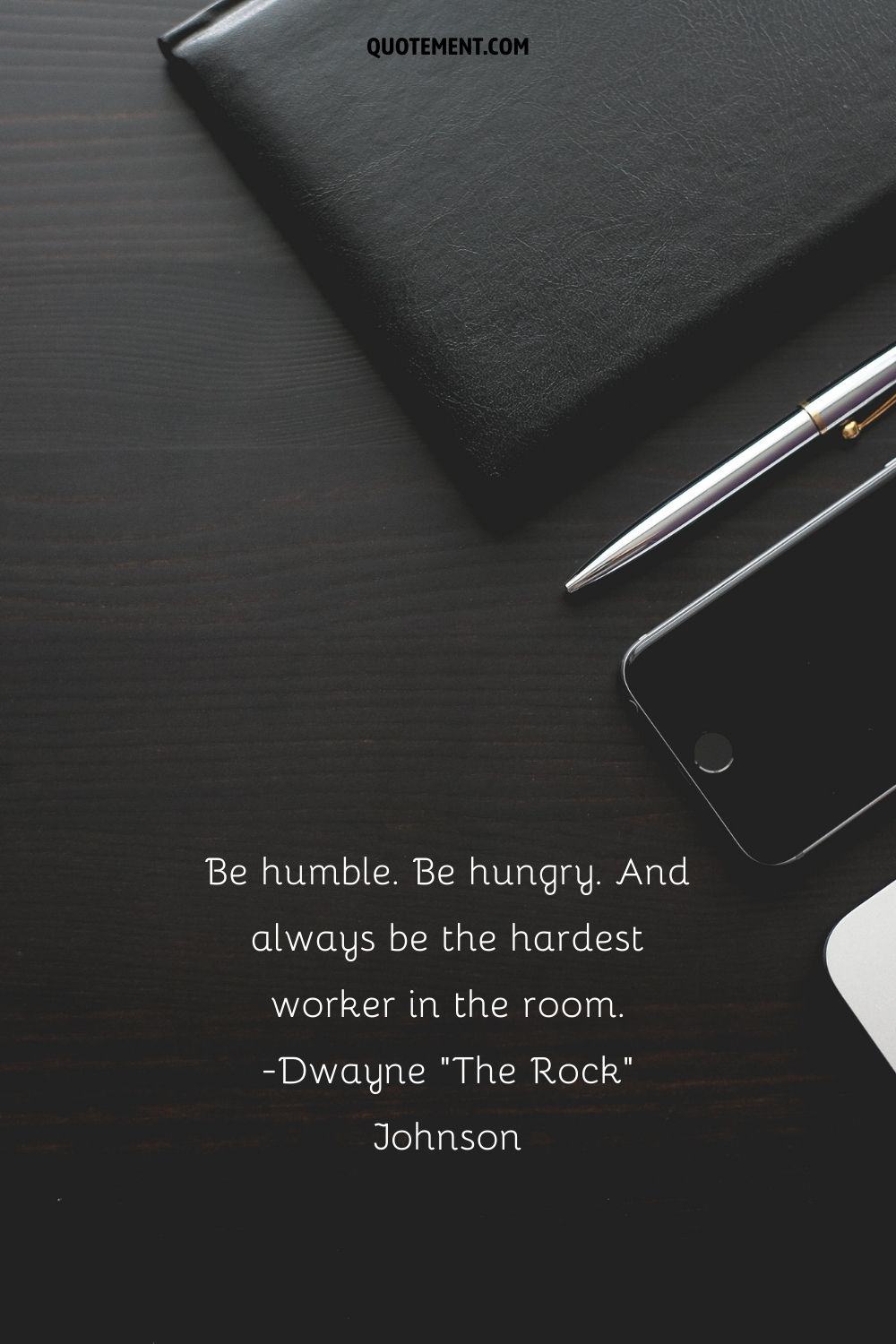 notebook, pen, and phone neatly arranged on the desk representing Wednesday work quote