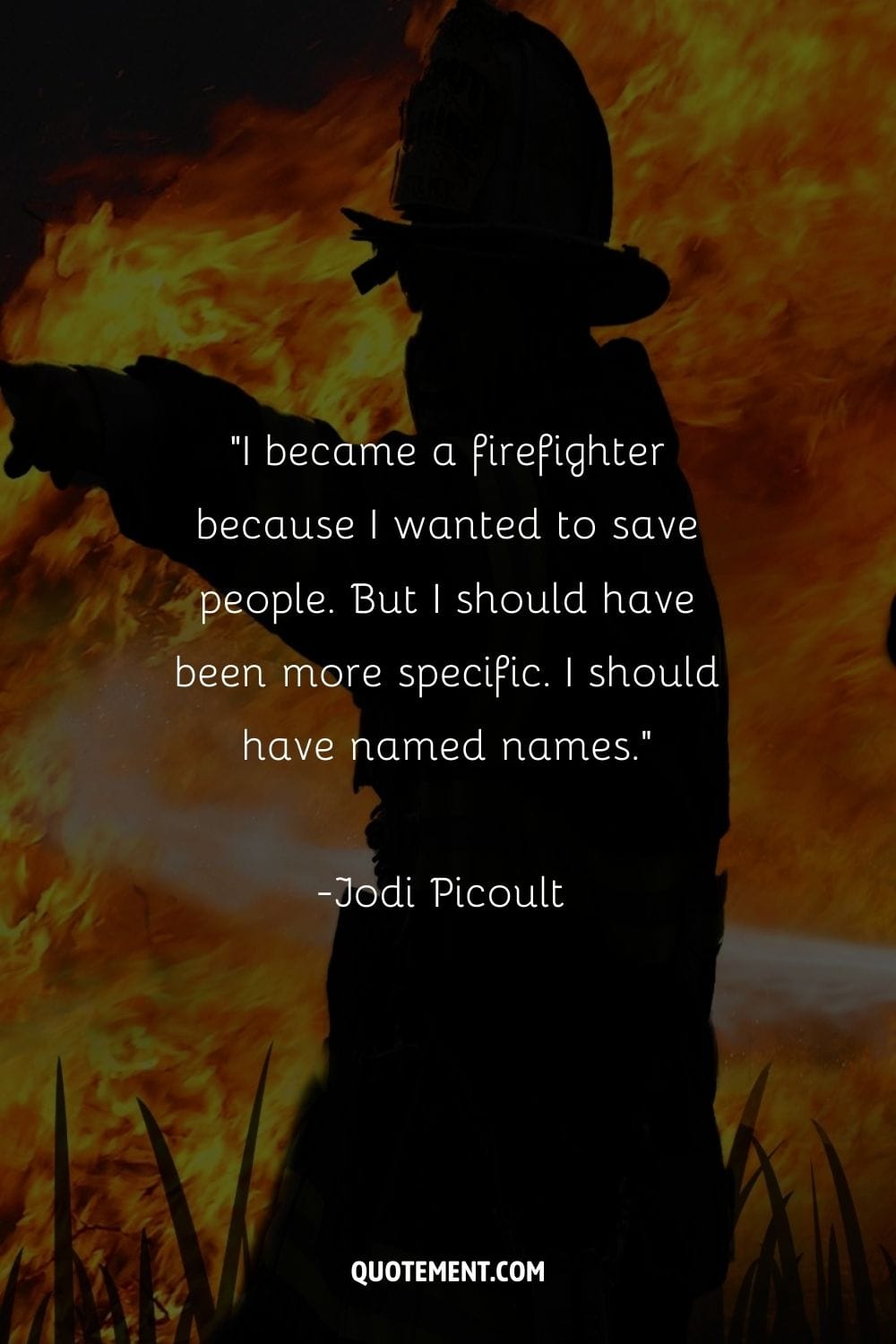 Firefighter stands surrounded by flames.
