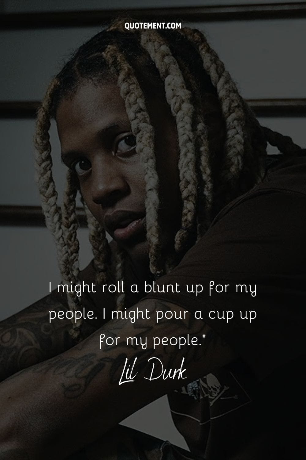 Lil Durk's laid-back charm in a brown tee, looking at the lens