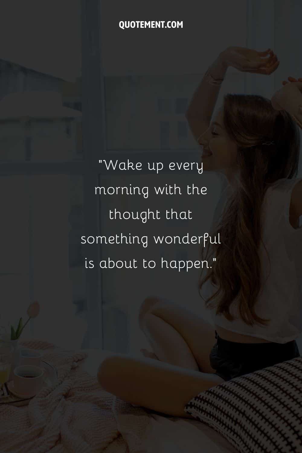 a smiling girl sitting on her bed her arms raised in delight representing inspirational morning quote