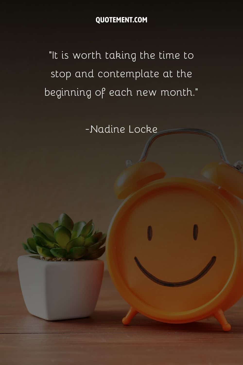an orange clock beside a lovely succulent plant representing top new month quote