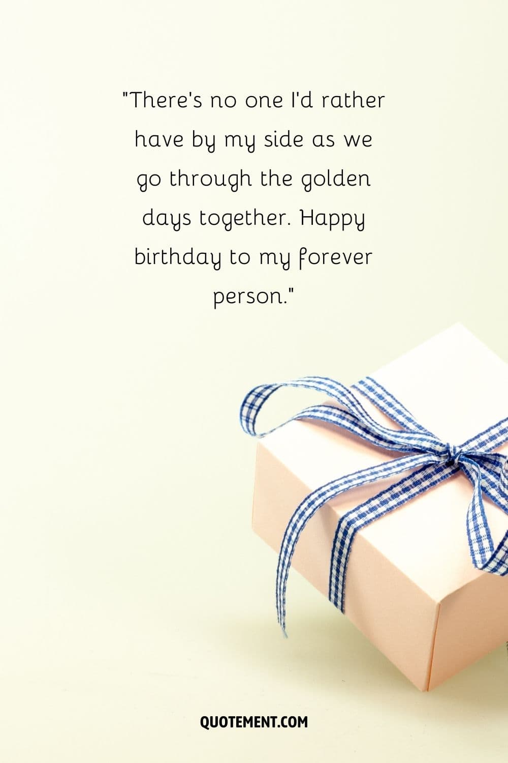 elegantly wrapped present with beige paper and a blue ribbon bow
