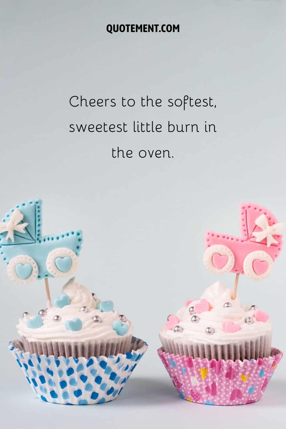 one cupcake with blue decorations and one with pink