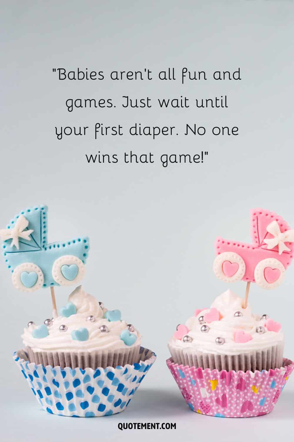 a pair of cupcakes decorated for a baby girl and a baby boy